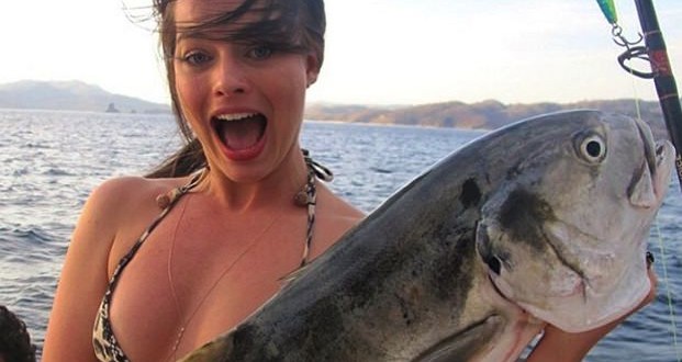 Margot Robbie holding a giant fish (Photo)