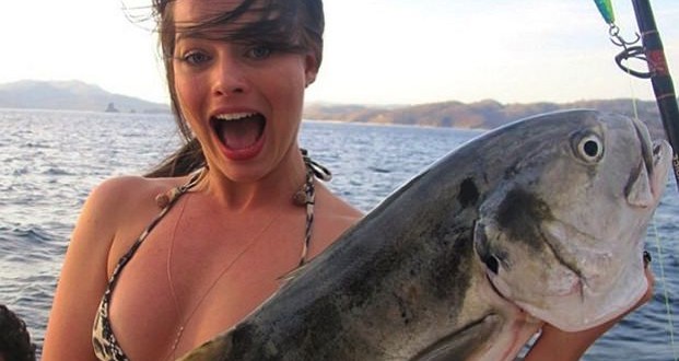 Margot Robbie holding a giant fish