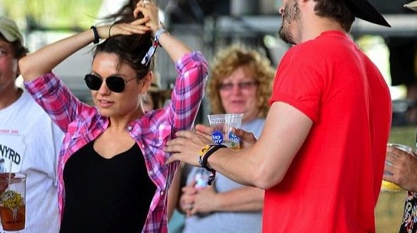 Mila Kunis flashes baby bump at music festival in California