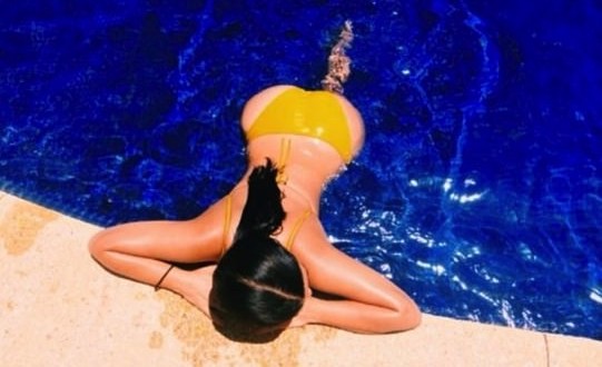 Kim Kardashian Shares Topless Poolside Pic