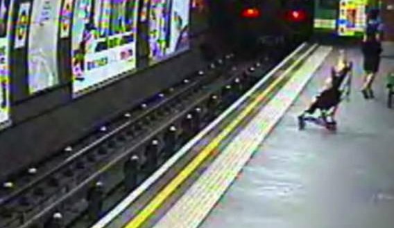 Toddler rescued from train tracks after pushchair rolls off platform (Video)