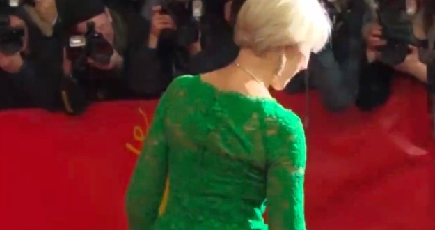 Helen Mirren trips up a step wearing skin tight emerald green dress (Video)