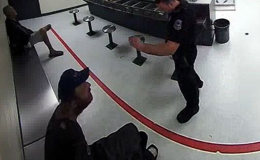 Andrew Halpin : Officer appears to throw food at man in handcuffs (Video)
