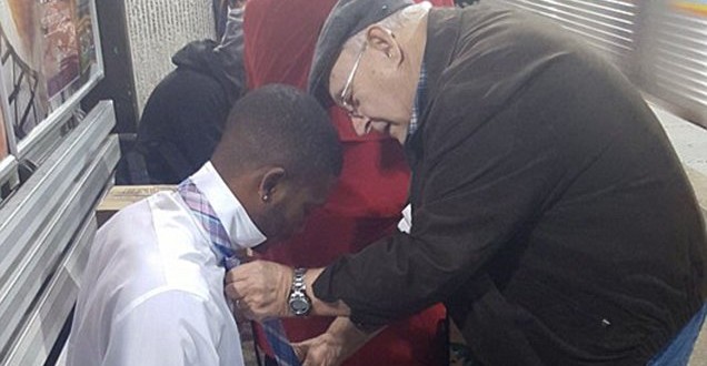 Image of couple teaching man how to tie his tie at Atlanta subway station
