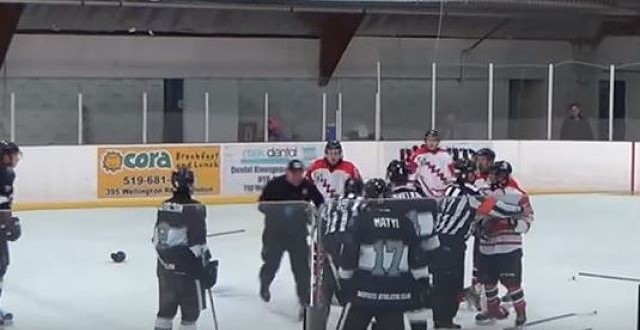 Linesman punches player, gets tackled by trainer (Video)