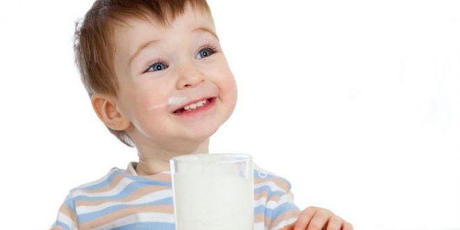 little child drinking yogurt or kefir over white